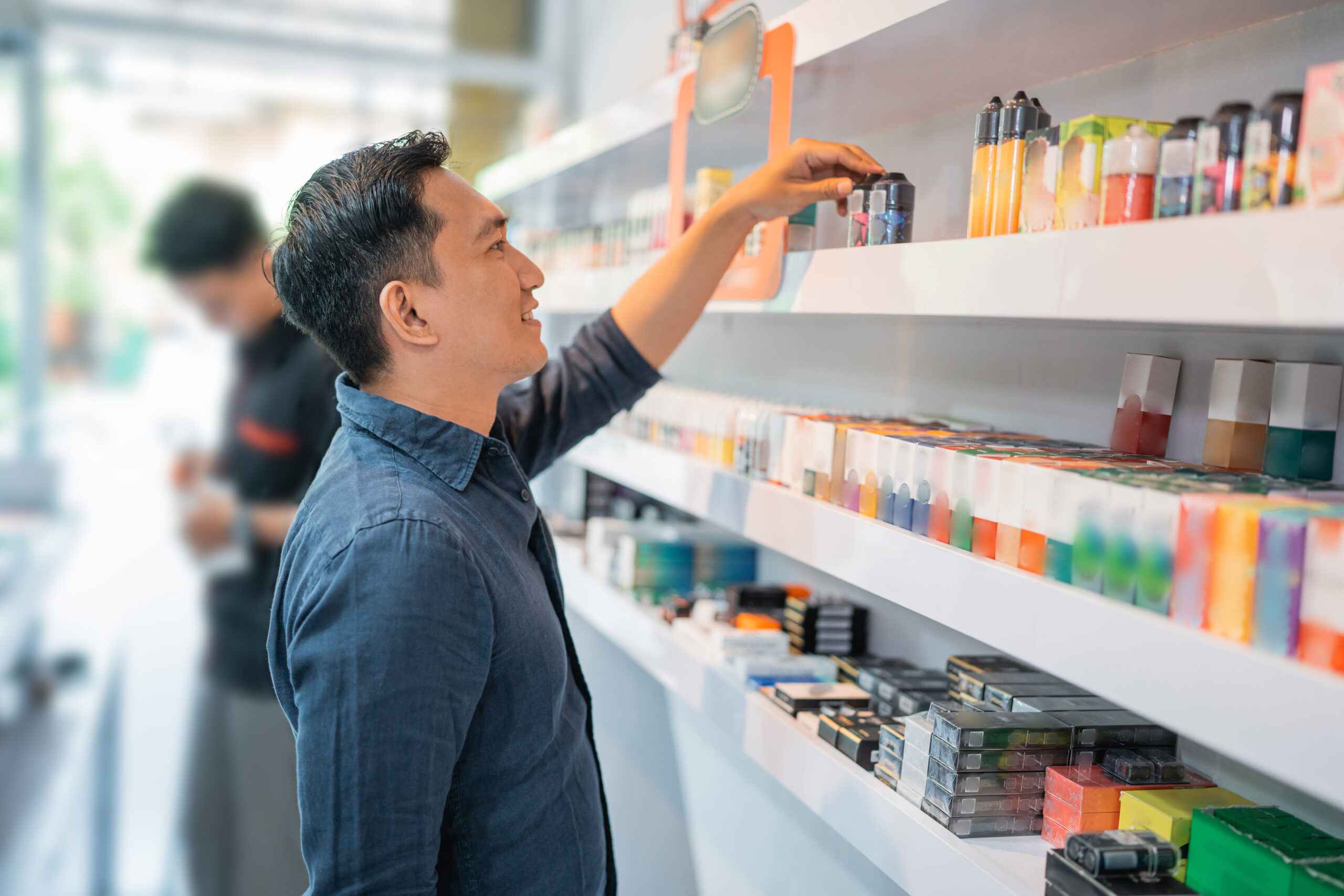 the male shop keeper organizing the liquids at the shelf